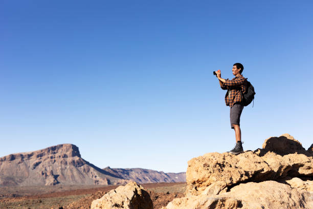 istock Man making memories on the mountain. 1571396292