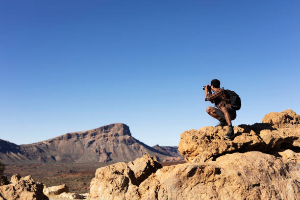 istock Man making memories on the mountain. 1571396501