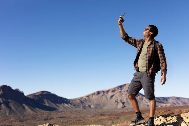 istock Man making memories on the mountain 1571410984