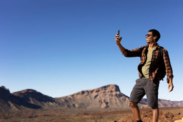 istock Man making memories on the mountain 1571411512
