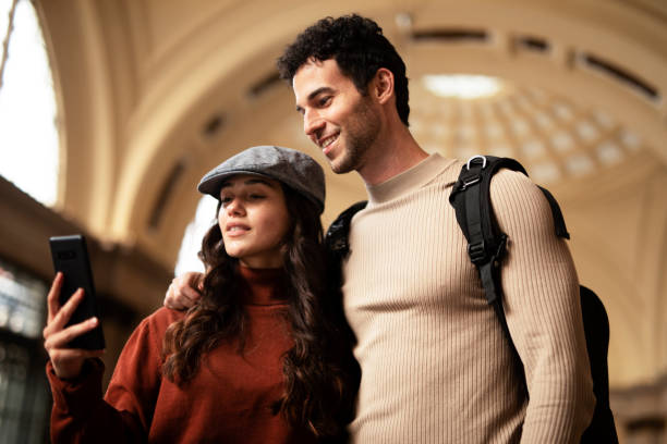 istock Loving couple walking through the city 1571415929