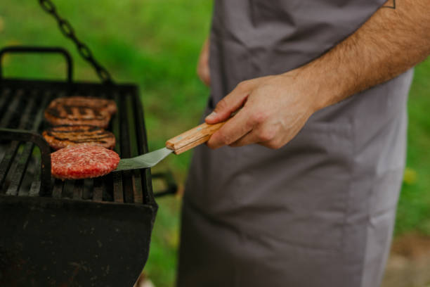istock A man grilling meat at barbecue outdoors 1571417582