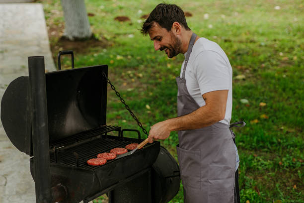 istock A man grilling meat at barbecue outdoors 1571419743