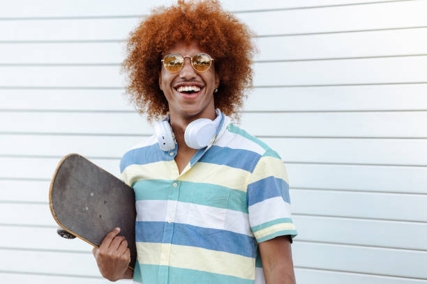 istock Portrait of a young man with skateboard 1571432947