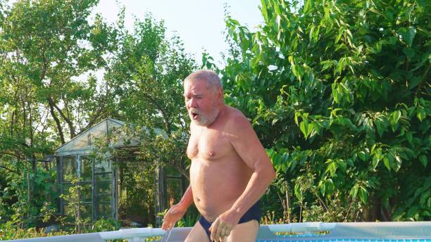 istock An elderly man bathes in a cold pool. 1571435578
