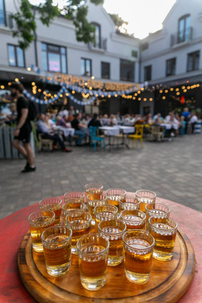 istock Small glasses filled with brandy on a wooden tray. 1571437825