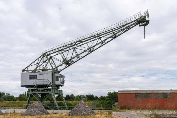 istock Port crane in the river port for loading ships. 1571441142