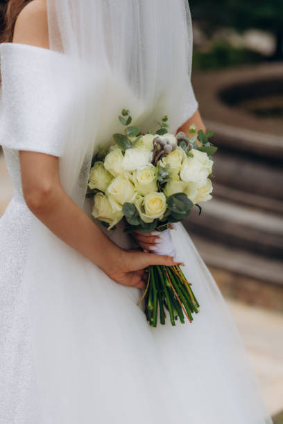 istock Wedding bouquet in bride's hands. beautiful wedding flowers. 1571441724