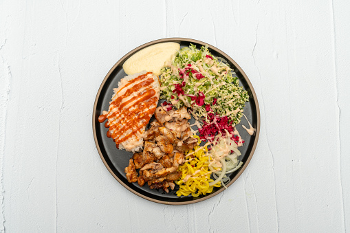 middle eastern lamb on rice dish with salad and hummus