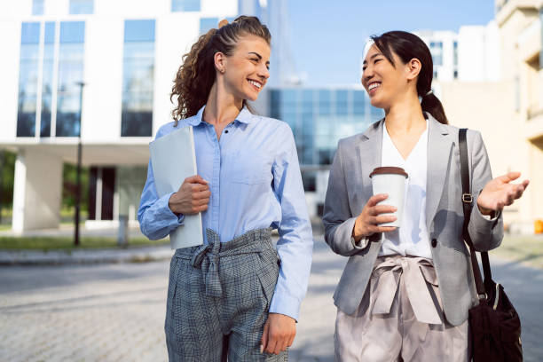 istock Two business women having a conversation in financial district 1571447525