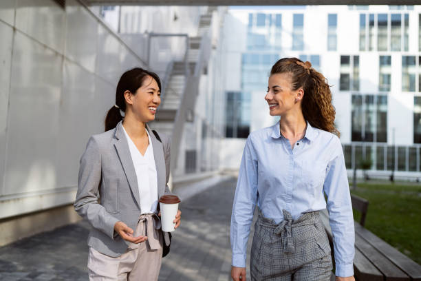 istock Two business women having a conversation in financial district 1571448568