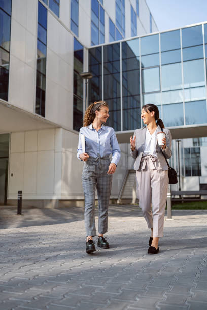 istock Two business women having a conversation in financial district 1571450226