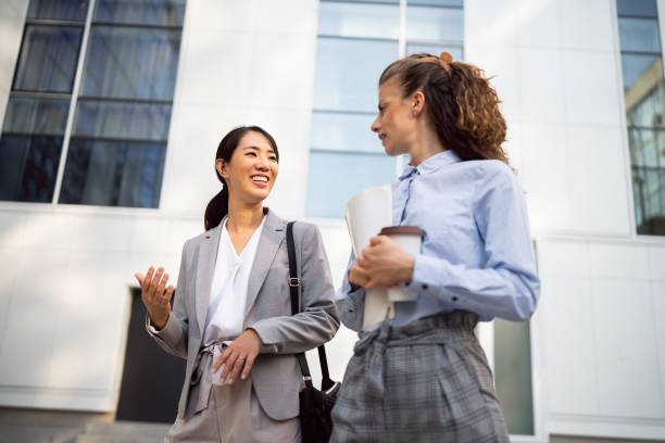 istock Two business women having a conversation in financial district 1571460687