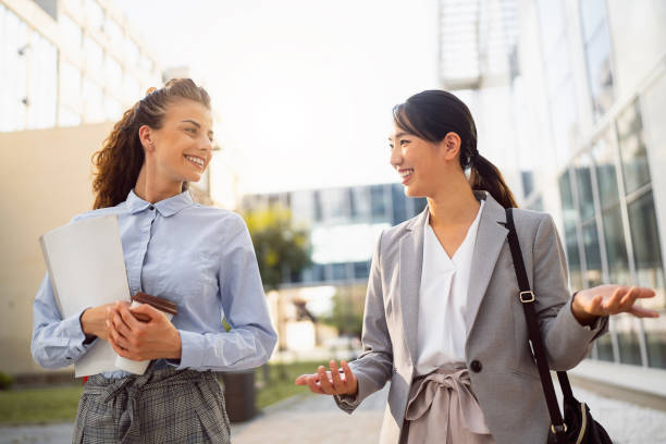istock Two business women having a conversation in financial district 1571461762