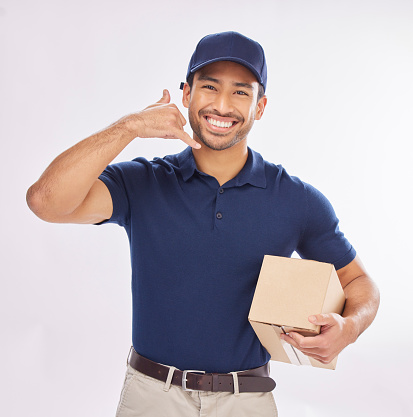 Contact us, delivery man and courier with phone gesture an happy to deliver package as ecommerce. Shipping, excited and employee or person with parcel using cellphone sign for communication