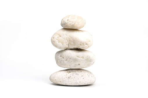 pile of white stones isolated on white background. Stones pyramid. Life balance and harmony concept