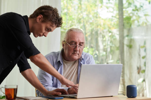 istock Showing Father how to Use Laptop 1571487844