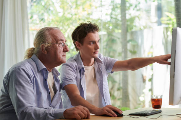istock Teenage Boy Explaining how to use Application 1571488378