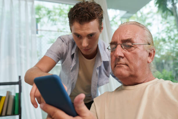 istock Man Helping to Install Dating App 1571488631