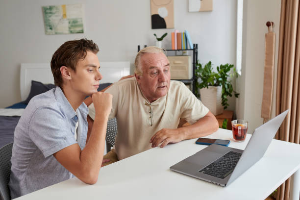 istock Grandfather and Grandson Watching Video 1571489470