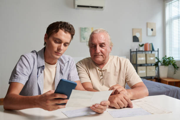 istock Man Paying Utility Bills of Grandfather 1571489505