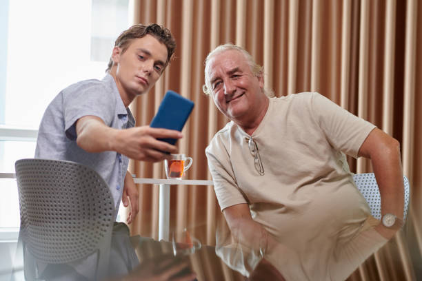istock Man Taking Selfie with Grandfather 1571489507