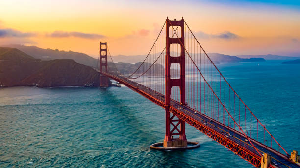 View of Golden Gate Bridge Aerial view of traffic moving on Golden Gate Bridge during sunset, San Francisco, California, USA. golden gate bridge stock pictures, royalty-free photos & images