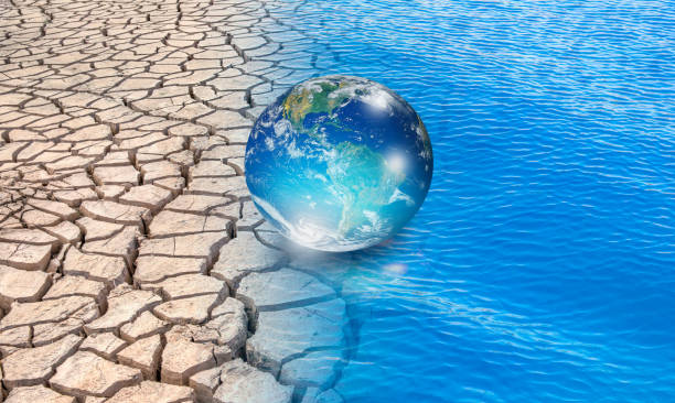 istock Water crisis and Climate change concept with earth planet on dry soil and water 