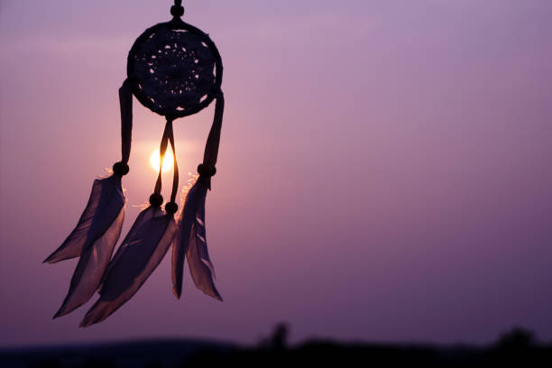 Dreamcatcher sunset , with white feather thread and beaded string. Handmade Dreamcatcher.The light of the setting sun. purple.
