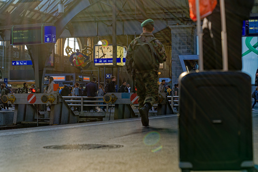 Swiss Army soldier with camouflage pattern uniform at main railway station of City of Zürich on a sunny spring morning. Photo taken May 22nd, 2023, Zurich, Switzerland.