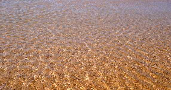 Calm ripples on the water surface at a beach in Ericeira, Portugal