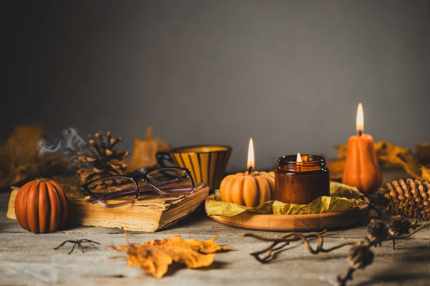 istock Halloween Still Life with Pumpkin Shaped Candles 1571530769