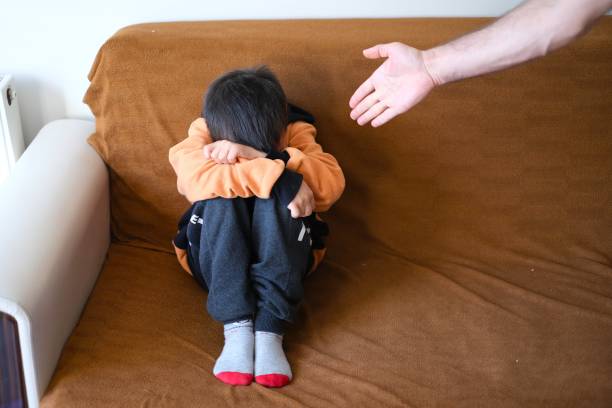 istock Little boy hides his face 1571546390