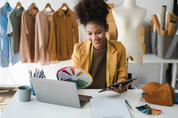 istock Fashion designers work in studios. 1571547489