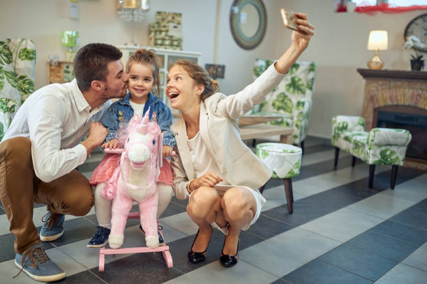 Family captures fun moments amongst beautiful lighting Family captures fun moments amongst beautiful lighting indeed three way kiss stock pictures, royalty-free photos & images