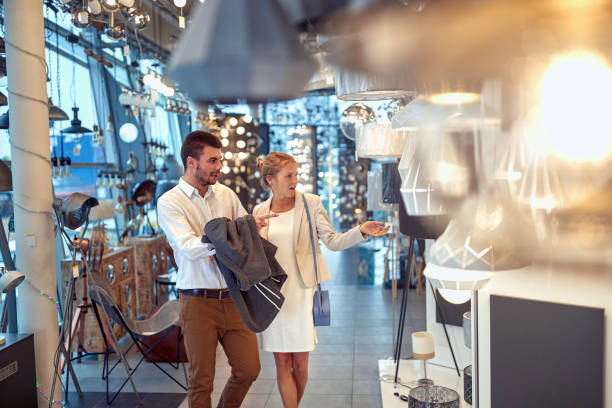 istock Couple Choosing Lamps for Their Home Interior 1571565015