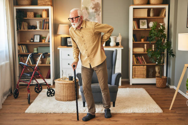 istock Elderly man with walking cane at home 1571567781