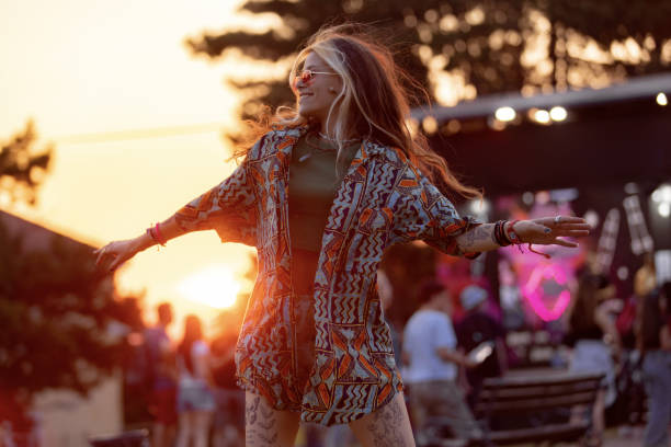 istock Carefree festival goer having fun while dancing at sunset. 1571578073