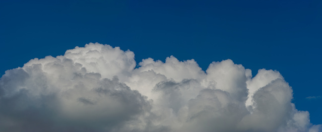 This is a complete anvil cloud consisting of mostly ice above a thunderstorm. The rising air is expanding and spreading the cloud as it hits the bottom of the stratosphere. Shot in the evening with the sun at my back showing the deep blue color in the sky above the storm.