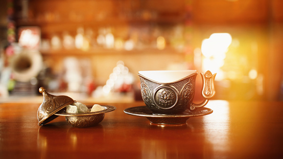 Porcelain cups, beautiful porcelain cups arranged on rustic wood, dark background, selective focus.