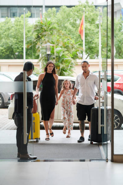 istock Family Entering Hotel Hall 1571598007