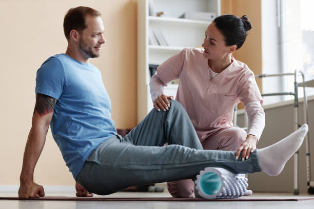 istock Patient exercising with therapist during rehabilitation 1571608516