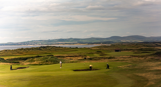 People playing golf fields at irvine troon ayrshire near glasgow scotland england UK