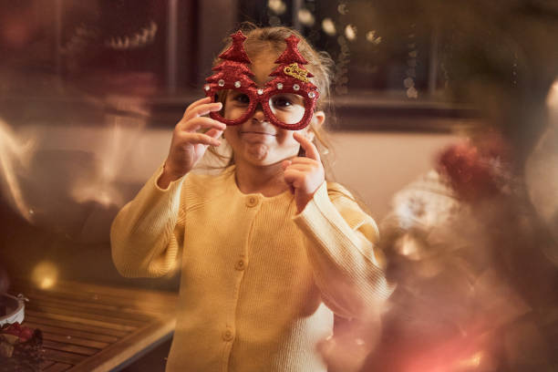 istock Happy girl decorating Christmas Tree 1571622699