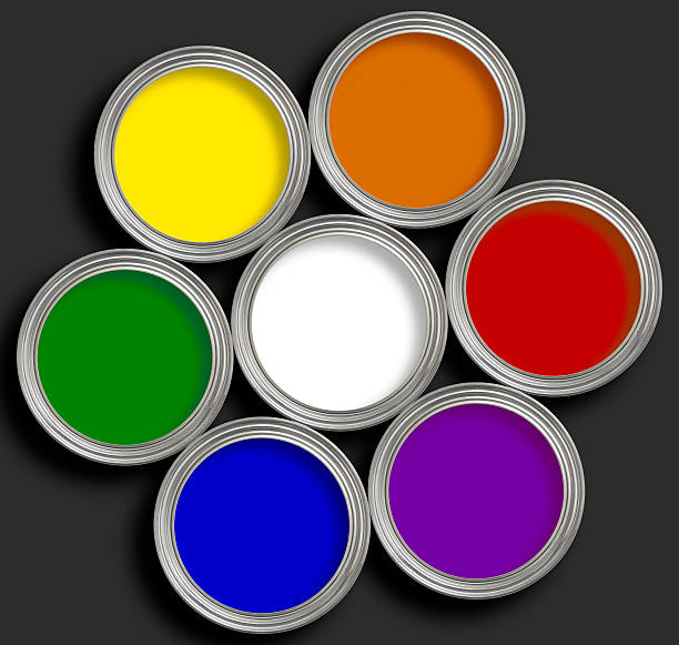 istock Paint wheel of multi colored paints tins on black 157162707