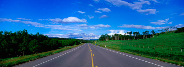 Panoramic picture of highway leading off to the mountains to getaway