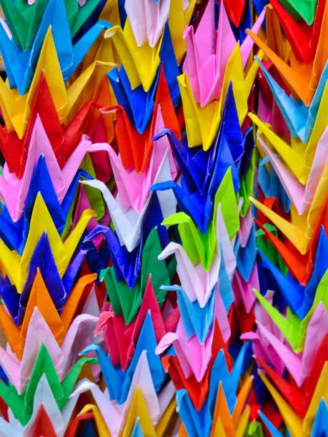 istock Colorful origami cranes in rows 1571635228