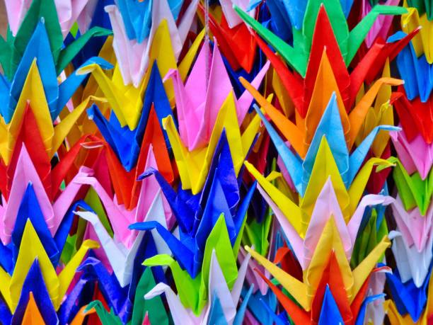 Colorful origami cranes in rows