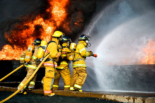 Fire Fighting Fire Fighters battle a blaze. fire hose photos stock pictures, royalty-free photos & images
