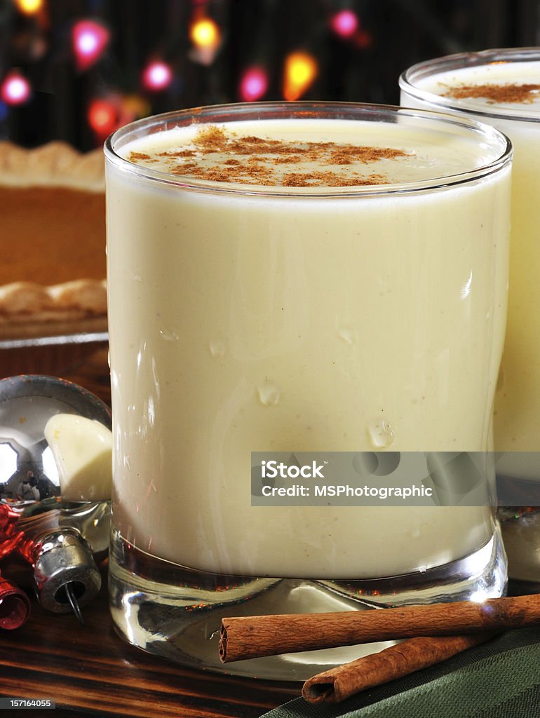 Christmas egg nog Glasses of holiday egg nog with a pumpkin pie in the background Alcohol - Drink Stock Photo